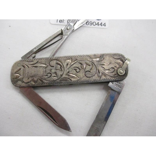 2096 - An engraved stirling silver pocket knife with 2 blades, nail file and scissors.