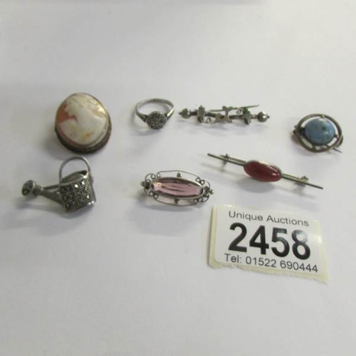 2458 - A mixed lot of vintage silver jewellery including watering can, ring, brooches etc.,