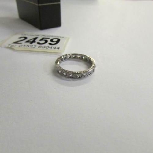 2459 - A 9ct white gold stamped stone set eternity ring, vintage with chased gold work to mounts, size K.