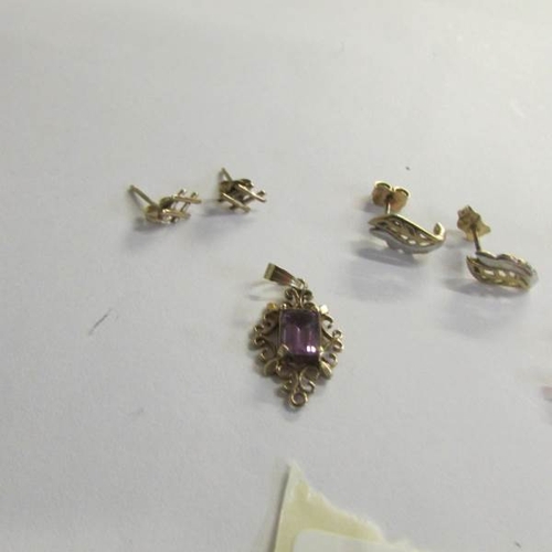 2462 - 3 pairs of 9ct gold earrings in fancy stud designs, amethyst pendant and a cross.