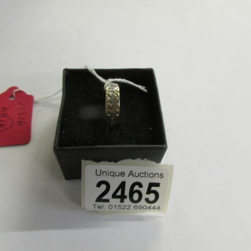 2465 - A circa 1970's textured wedding band, stone set, stamped 9ct.