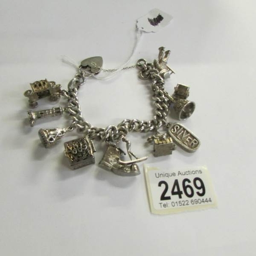 2469 - A very good quality 1970's charm bracelet with 11 charms in total including 4 opening, with heart cl... 