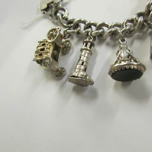 2469 - A very good quality 1970's charm bracelet with 11 charms in total including 4 opening, with heart cl... 