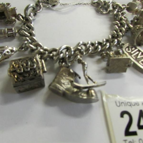 2469 - A very good quality 1970's charm bracelet with 11 charms in total including 4 opening, with heart cl... 