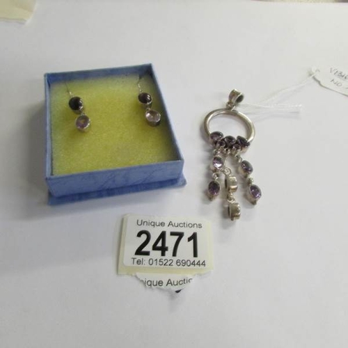 2471 - An amethyst stone set three drop pendant in silver with a pair of amethyst drop earrings with shephe... 