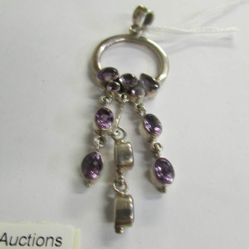 2471 - An amethyst stone set three drop pendant in silver with a pair of amethyst drop earrings with shephe... 