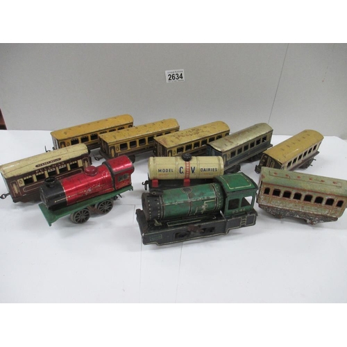 2634 - Box containing various tin plate railway carriages and two clockwork locomotives