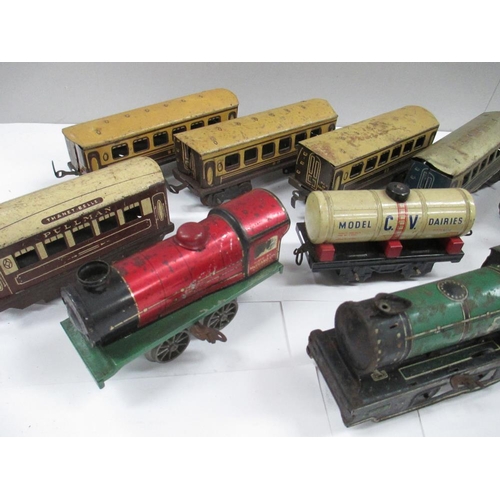 2634 - Box containing various tin plate railway carriages and two clockwork locomotives