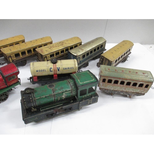 2634 - Box containing various tin plate railway carriages and two clockwork locomotives