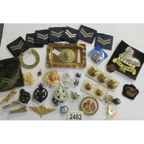 2482 - A mixed lot of military badges, buttons etc.,