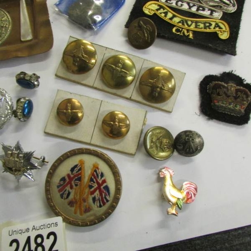 2482 - A mixed lot of military badges, buttons etc.,