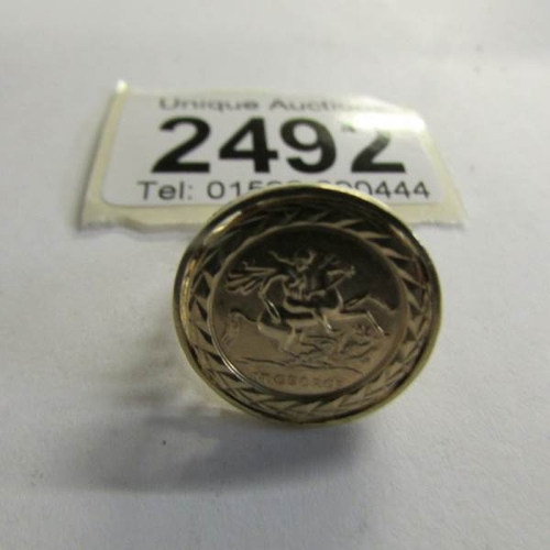 2492 - A 9ct gold ring set with St. George coin,  Size M half.