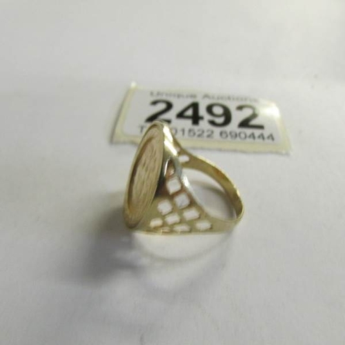 2492 - A 9ct gold ring set with St. George coin,  Size M half.