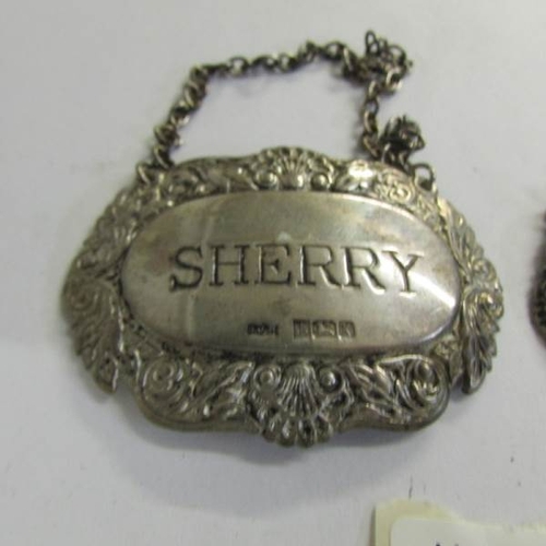 2499 - A silver sherry label and a silver whisky label.