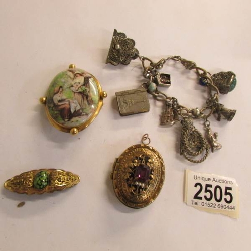 2505 - A Yellow metal pendant, 2 brooches and a charm bracelet.