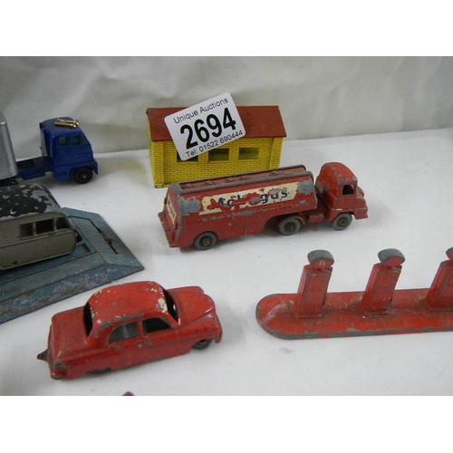 2694 - A quantity of early Lesney matchbox models including petrol pumps, garage etc.,