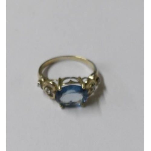 2514 - A 9ct gold blue topaz and diamond ring, size M half.