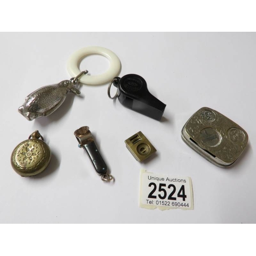 2524 - A penguin rattle, 2 cigar cutters, a sovereign case, a coin case and a whistle.