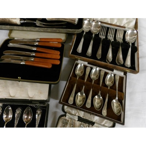 2544 - A mixed lot of cased cutlery including fish servers, carving set, spoons, knives etc.,