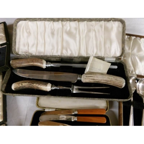 2544 - A mixed lot of cased cutlery including fish servers, carving set, spoons, knives etc.,