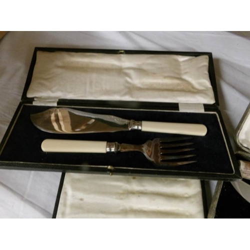 2544 - A mixed lot of cased cutlery including fish servers, carving set, spoons, knives etc.,