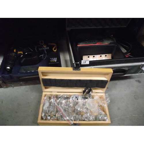 12 - A Bosch cast with sander, box of wood drill bits, boxed drill with battery and empty case.