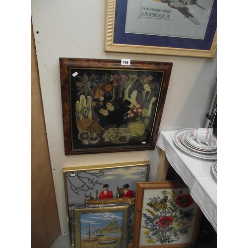 194 - A large lot of embroidered pictures, some framed and glazed and an embroidery kit