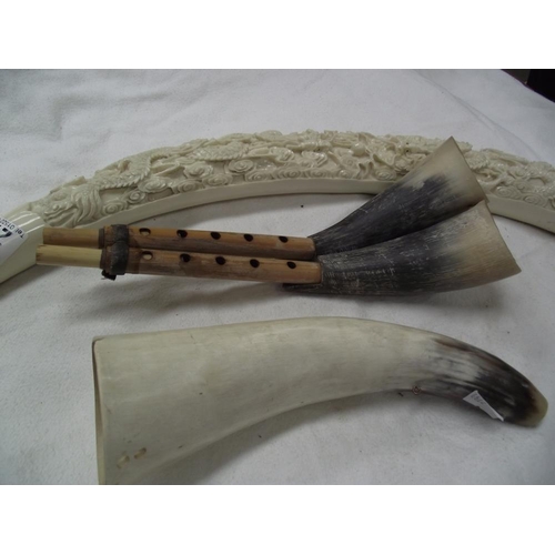 277 - A resin elephant tusk ornament & 2 cow horn musical instruments