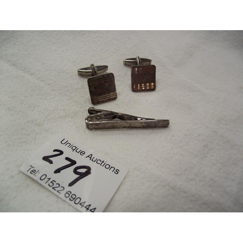 279 - A pair of silver cufflinks and matching tie-pin