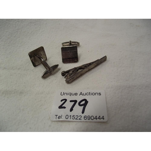 279 - A pair of silver cufflinks and matching tie-pin