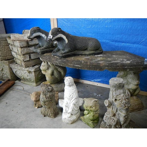 664 - 2 concrete badgers and 5 other garden ornaments.