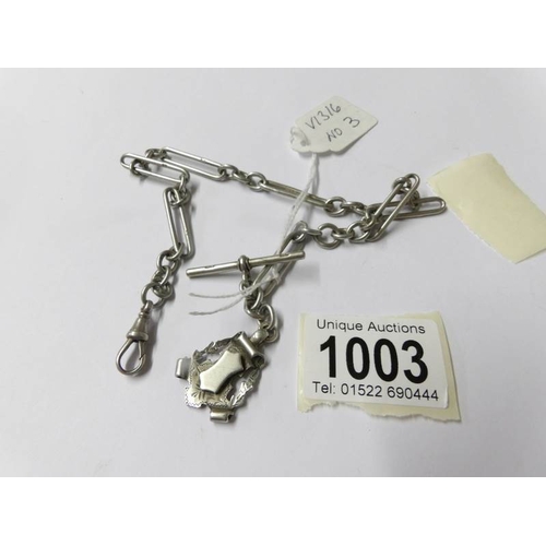 1003 - A silver full Albert chain, fancy link, dated Birmingham 1901 with shield shape fob.  33.8 grams.