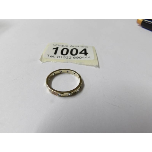 1004 - A 9ct gold eternity ring, white stone set, dated Birmingham 1989, full hoop, size M, 2 grams.