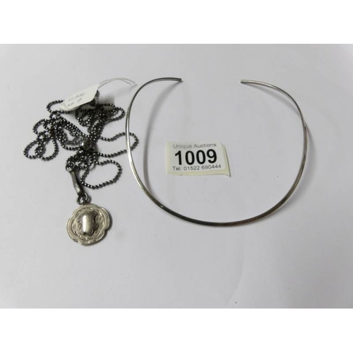 1009 - A silver collar necklace stamped T. S silver with a further long adjustable necklace with attached s... 