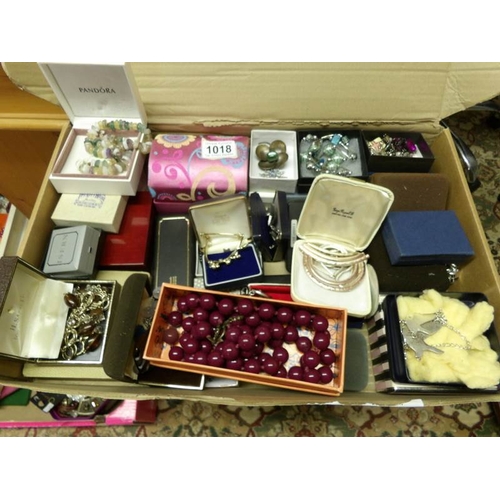 1018 - A large quantity of mixed jewellery including brooches, necklaces, bracelets etc.,