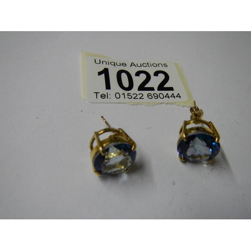 1022 - A pair of yellow gold and topaz earrings.