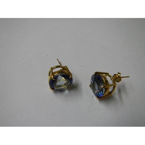 1022 - A pair of yellow gold and topaz earrings.