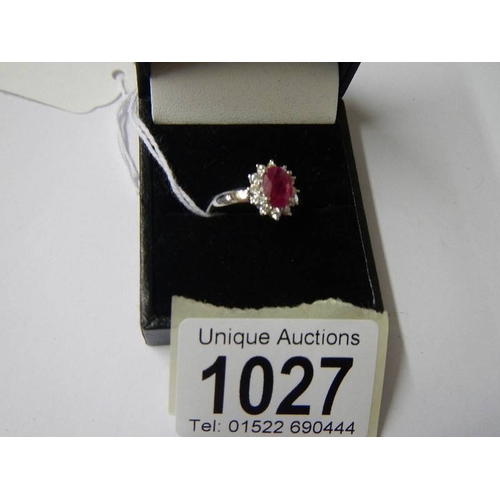 1027 - An 18ct gold ruby and diamond ring (Ruby 125, diamond 70pt), size M half.