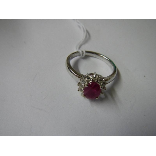 1027 - An 18ct gold ruby and diamond ring (Ruby 125, diamond 70pt), size M half.