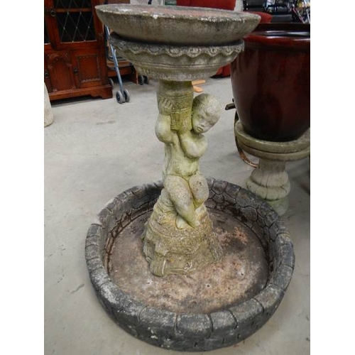 883 - A bird bath with cherub base.