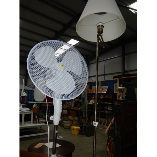 937 - An electric standard lamp and a freestanding fan.