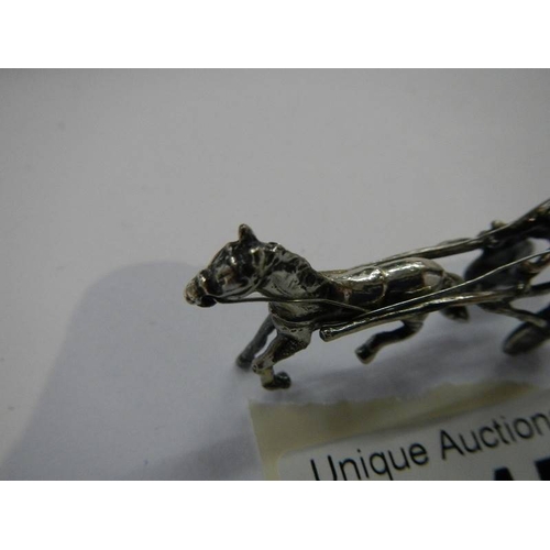 1045 - A miniature silver horse and trap.