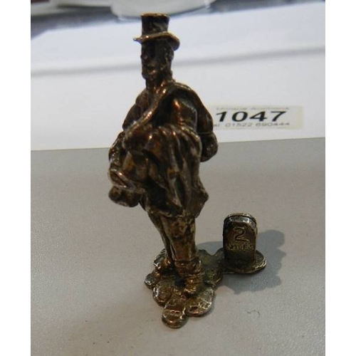 1047 - A miniature silver tramp figure.