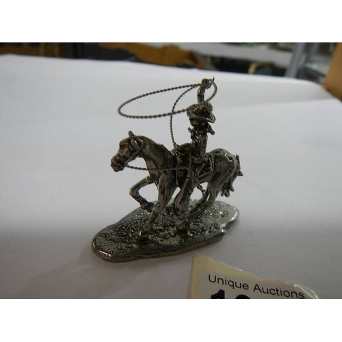 1050 - A white metal cowboy on horse with lasso together with a white metal American Indian on horse, (poss... 