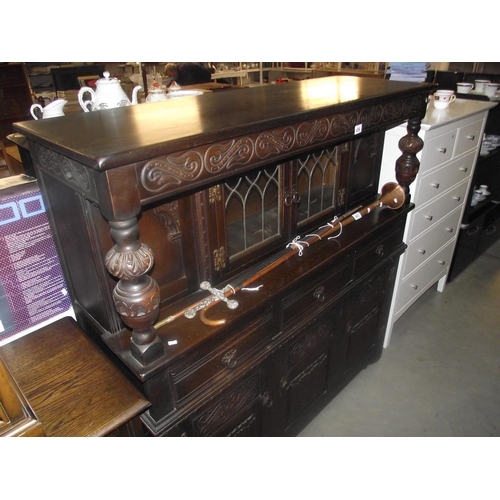 459 - A dark oak buffet cupboard with leaded glass doors