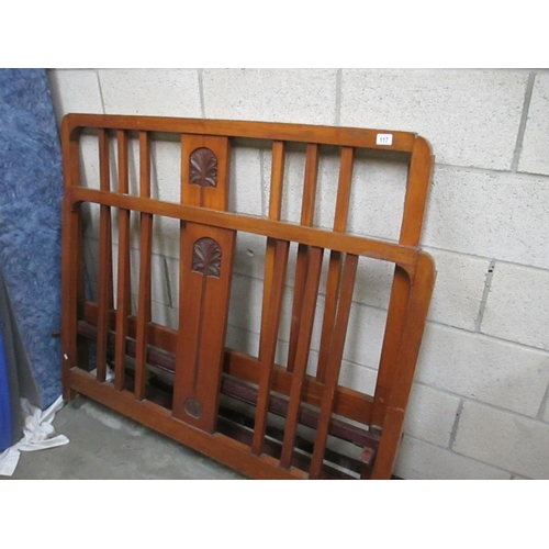 117 - An Arts and Crafts style carved bed frame (header, footer and metal side rails)