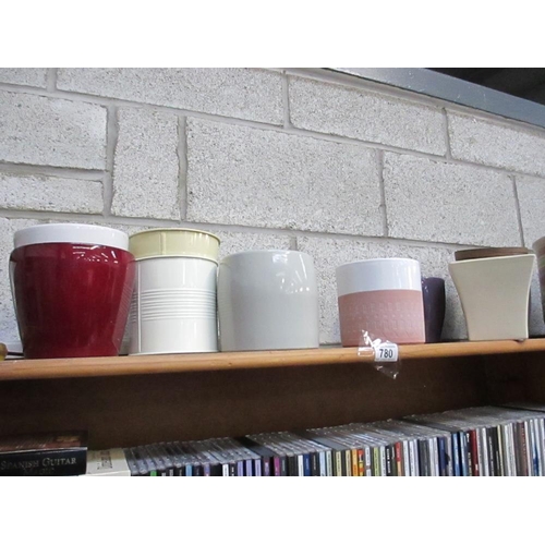 780 - A shelf of garden pots.