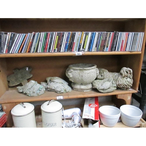 782 - A shelf of garden items including dogs, birds etc.,