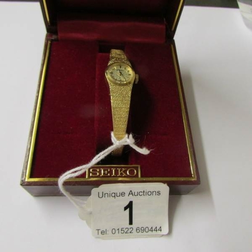 1 - A boxed Seiko make ladies wrist watch in yellow metal.