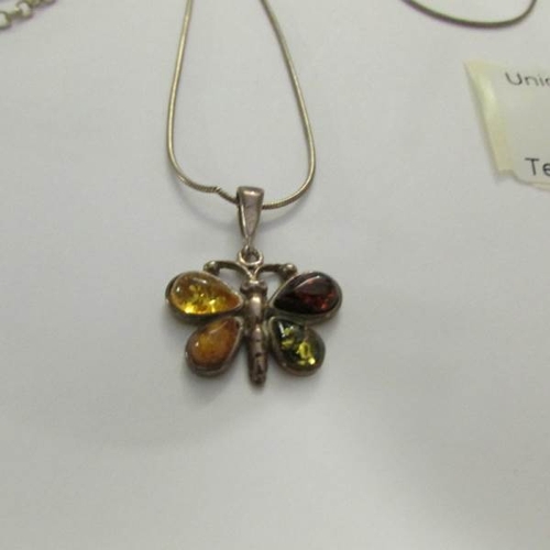 12 - 2 silver pendants, one set amber and the other marcasite.